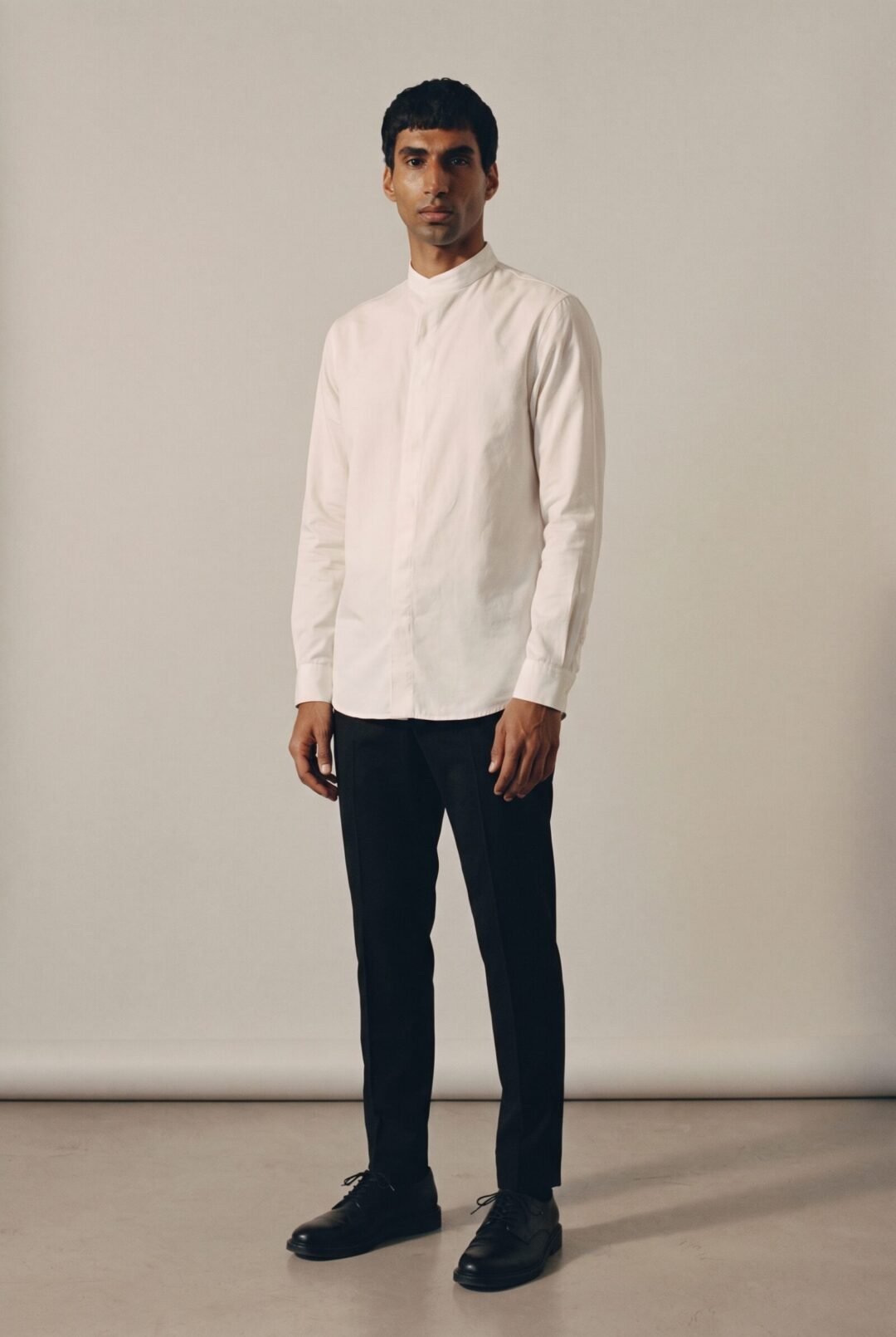 Ethan Naidoo, full length in a band collar shirt
