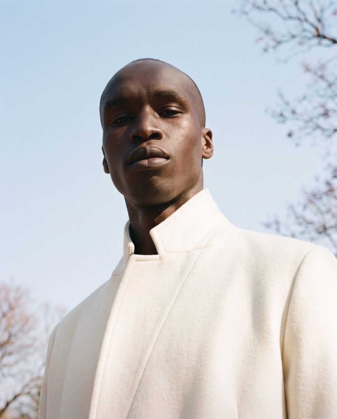Kagiso Molefe against a winter sky in an ivory coat
