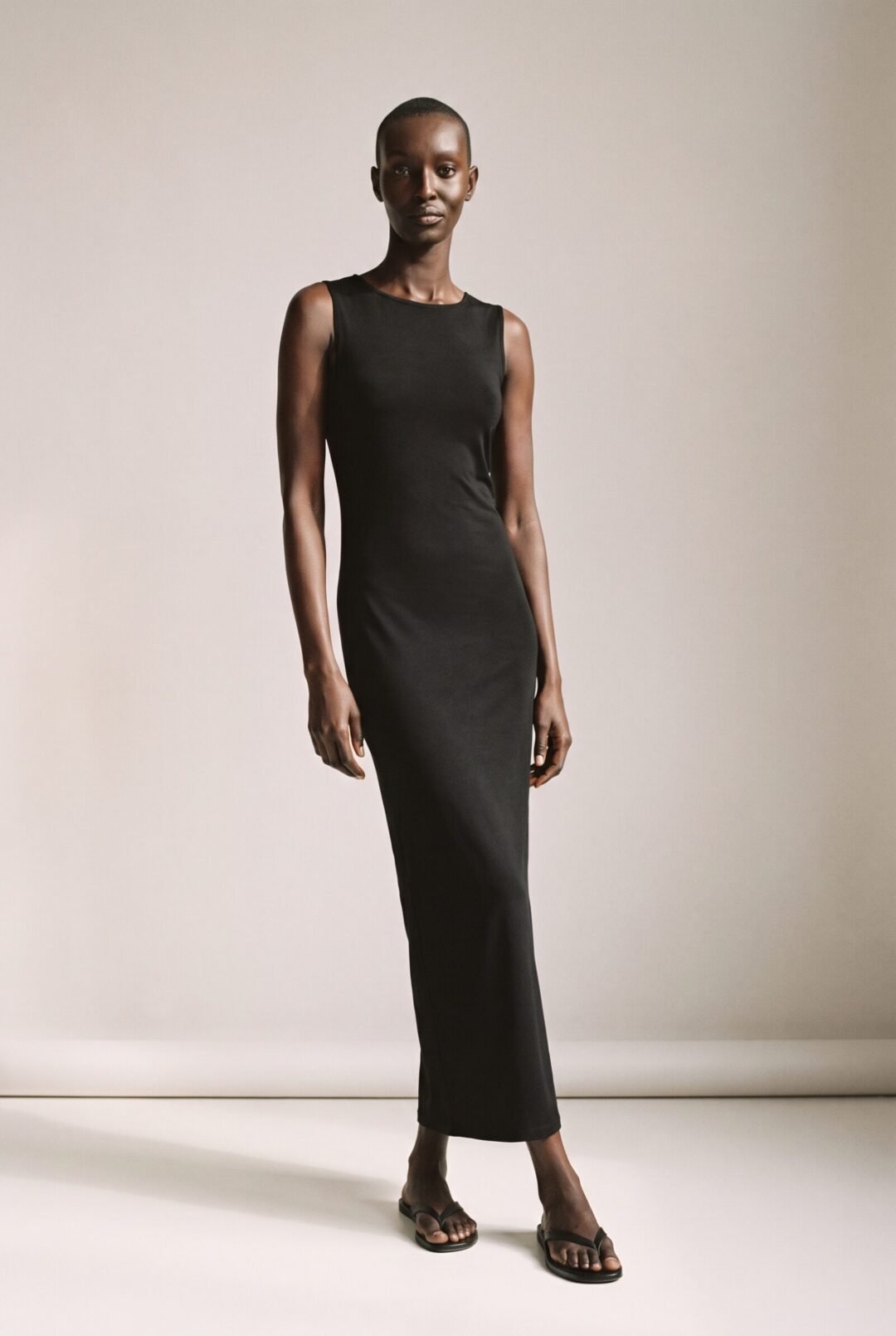 Naledi Mokoena, full length in a black column dress